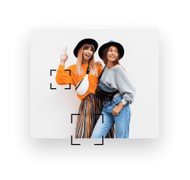 Image of two young women smiling and wearing trendy oufits